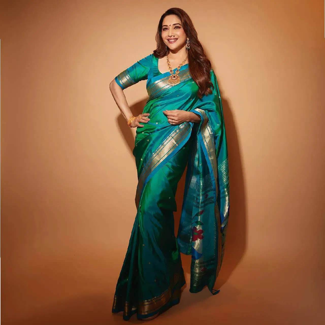 অভিনেত্ৰীগৰাকীয়ে পৰিধান কৰিছে বানাৰসী শাৰী। লগতে পৰিধাণ কৰিছে গহনা। সামান্য মেকআপ লগাই চুলিখনি খুলি ৰাখিছে।পূজা পাৰ্বনত এনে শাৰী, এনে মেকআপ কৰিব পাৰি।