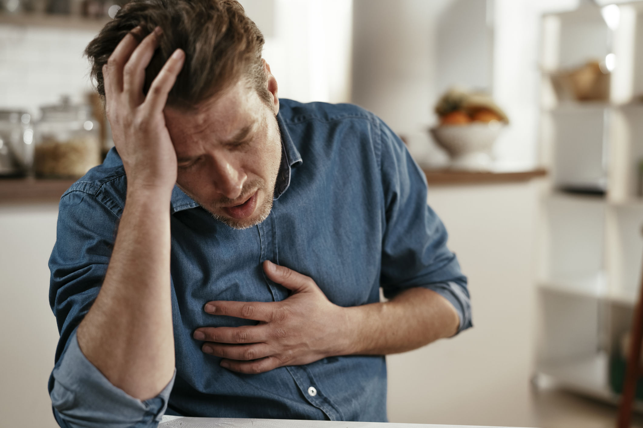Portrait Of Man Placing Hands On The Chest Suffering From Pain In The Heart.